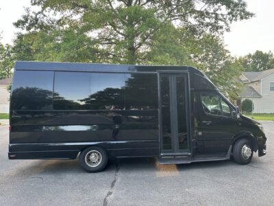 Black 14 passenger Sprinter Van
